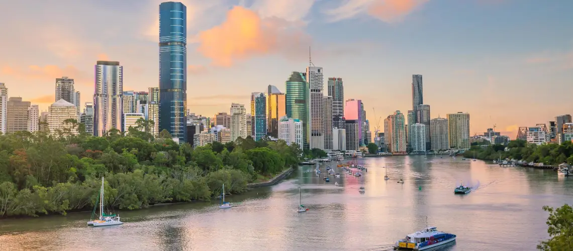 Brisbane skyline with property valuer assessing a property on-site